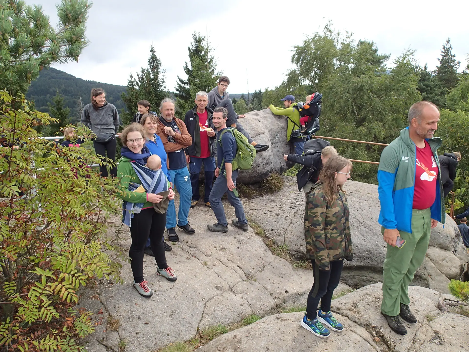 Eine Gruppe Wanderer steht auf einem Fels, im Hintergrund sind Hügel | © Christine Eyle